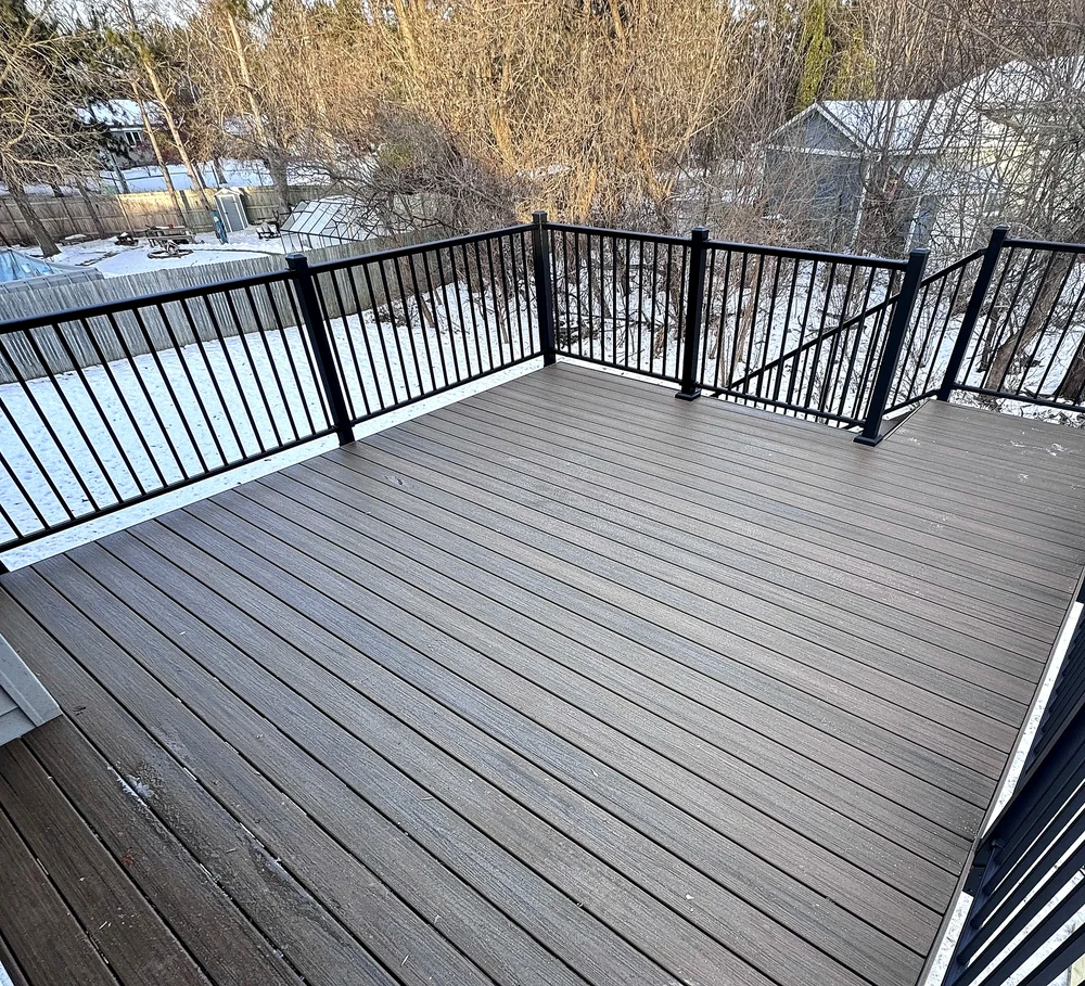 Close-up of composite decking and railing detail on a Home Improvement Partners deck project
